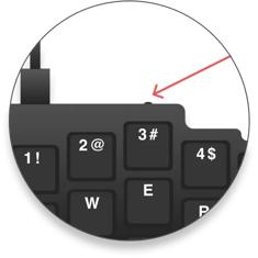 Red arrow pointing to a button on top of the 3 key on the default layout